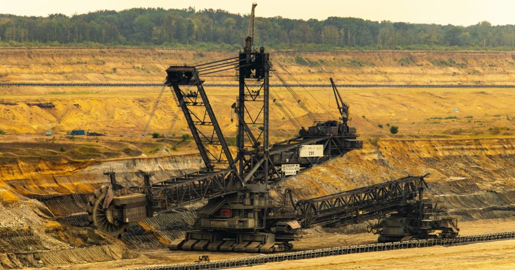 A giant bucket-wheel excavator operating in an open-pit mining site.